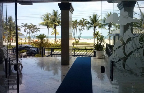 Guilhermina Apartment | High standard beach front av beach with parasol chairs installed on the beach