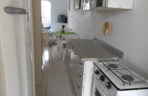 Pitangueiras Apartment | Charming kitnet ideal for couple 100 meters from the beach in Pitangueiras