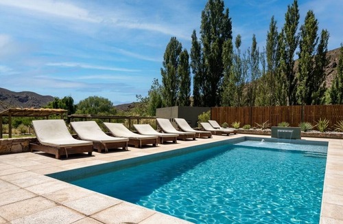 Vistalba Apartment | Family Room with River, Mountain, Spa, and Pool Views