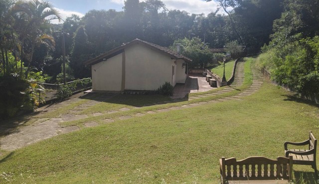 Entire single-story house embraced by nature in the Serra da Cantareira mountains.