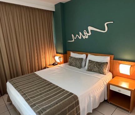 Praia do Canto Apart Hotel quarto sala e varanda