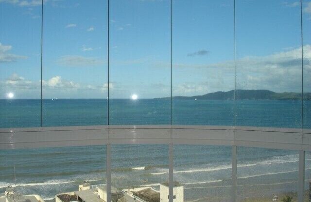 Apt. cover with great views of the sea front promenade, center.(See rates). in Itapema