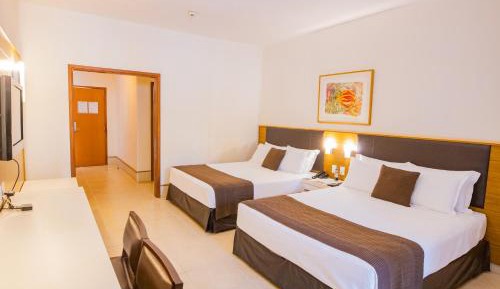 Deluxe with two double beds and pool view